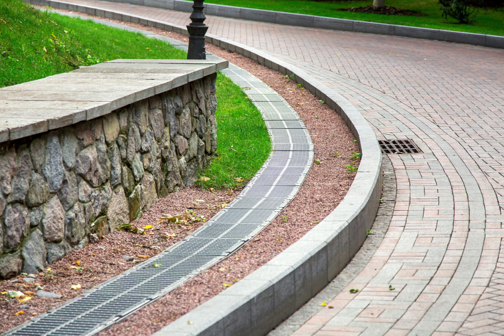 grille of the drainage system manhole on the curve pedestrian si