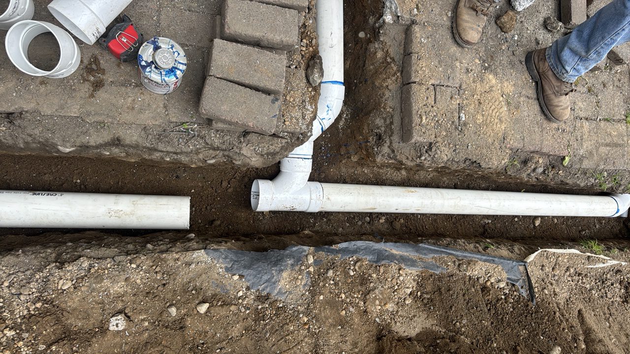 Downspout drain built through a paver walkway.